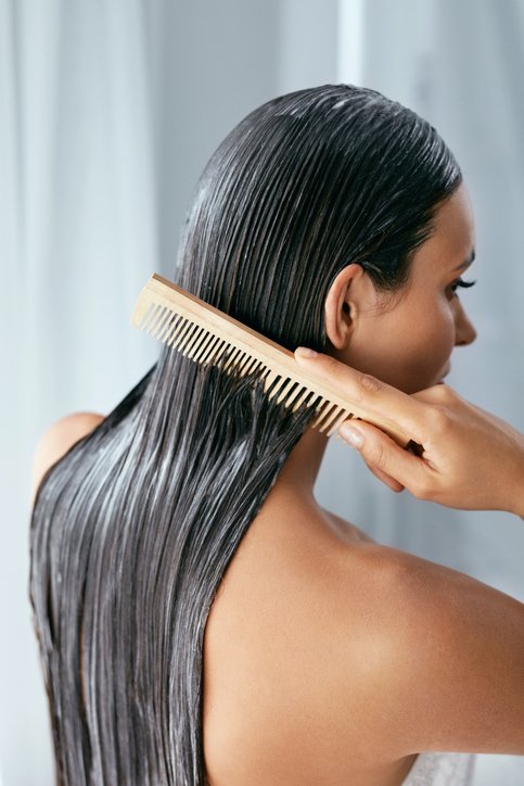 Girl using hair conditioner in the shower